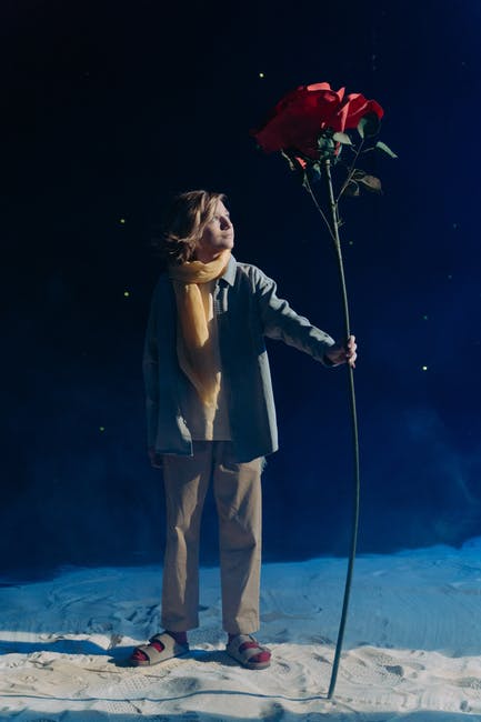 Kid dressed up as The Little Prince holding a giant rose